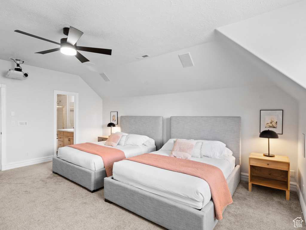 Bedroom with lofted ceiling, visible vents, carpet flooring, and a ceiling fan