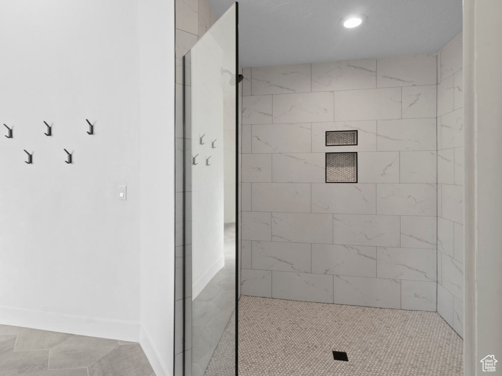 Bathroom with baseboards, walk in shower, and recessed lighting