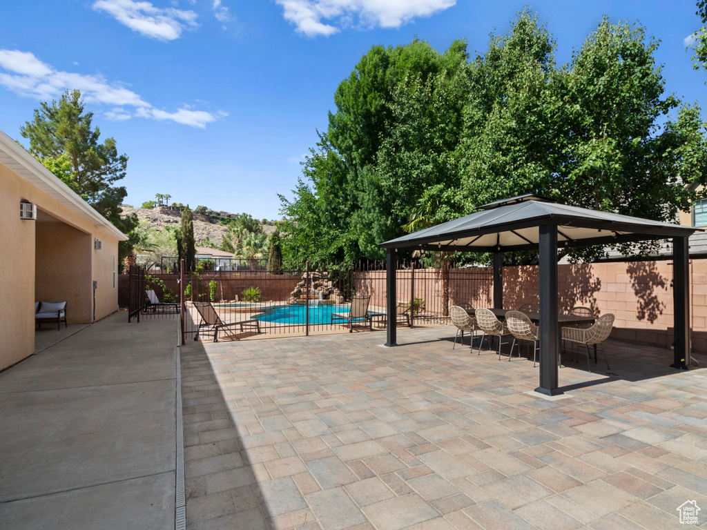 View of pool with a fenced backyard, a fenced in pool, a gazebo, and a patio