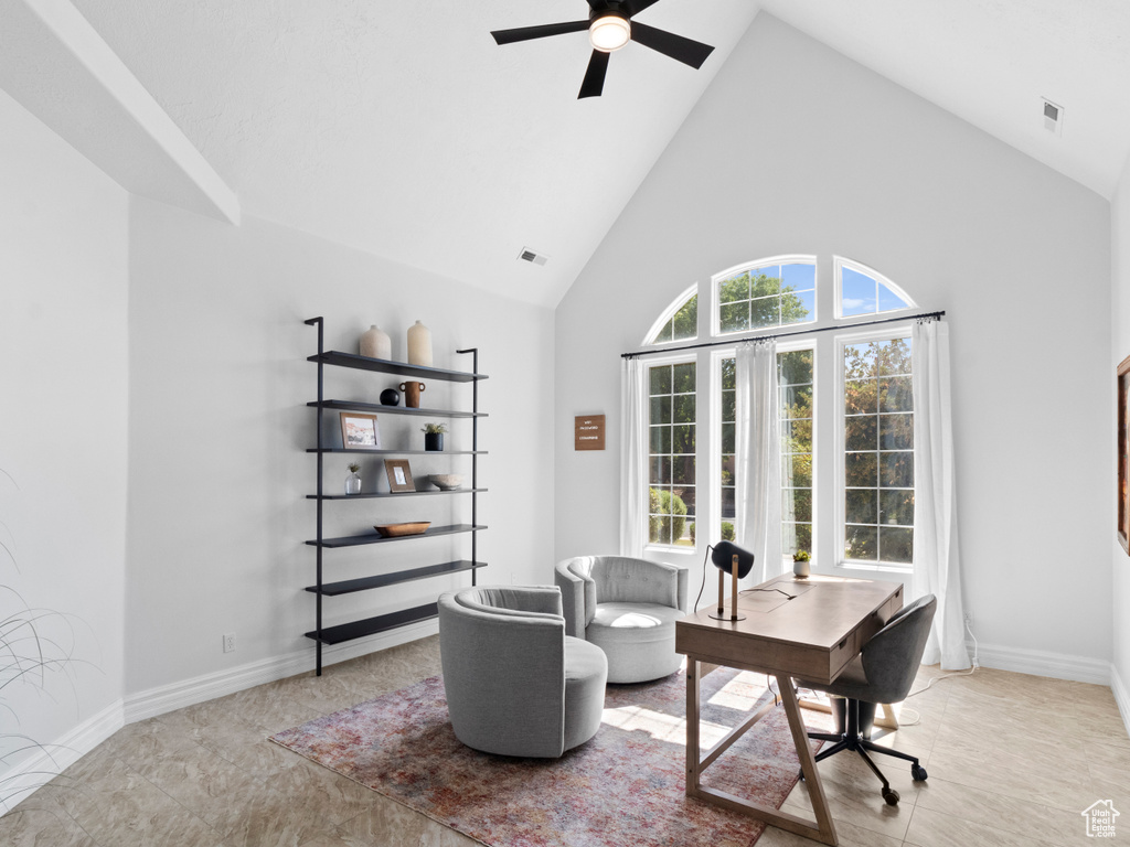 Office space featuring baseboards, a ceiling fan, visible vents, and high vaulted ceiling