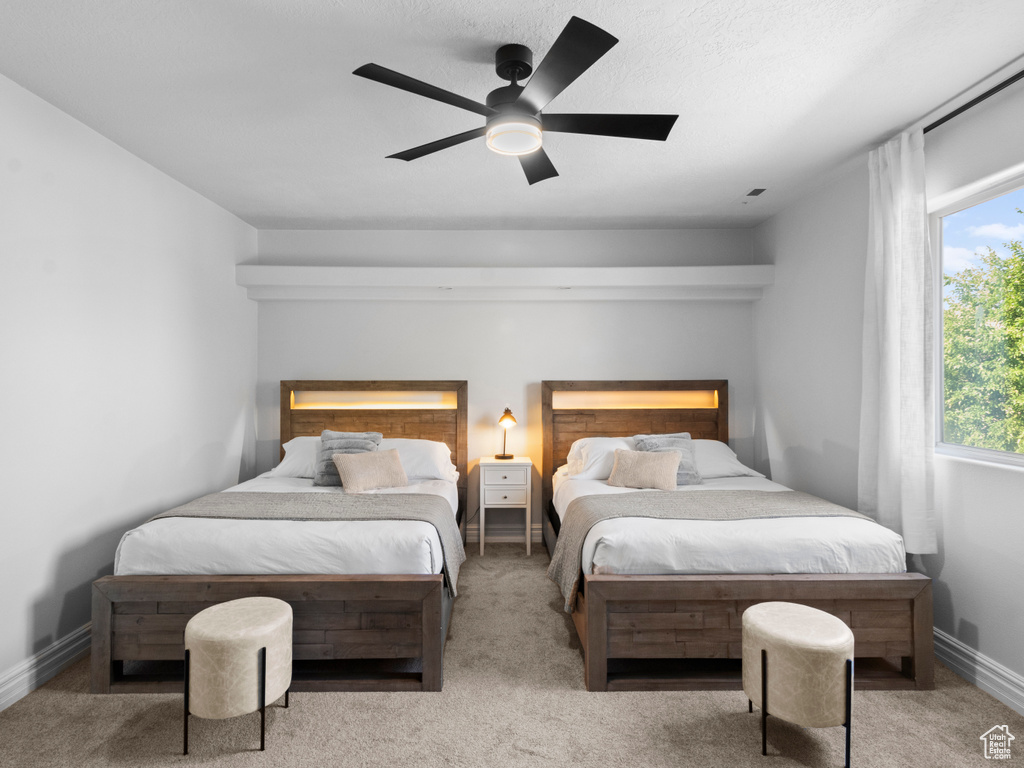 Carpeted bedroom with baseboards and ceiling fan
