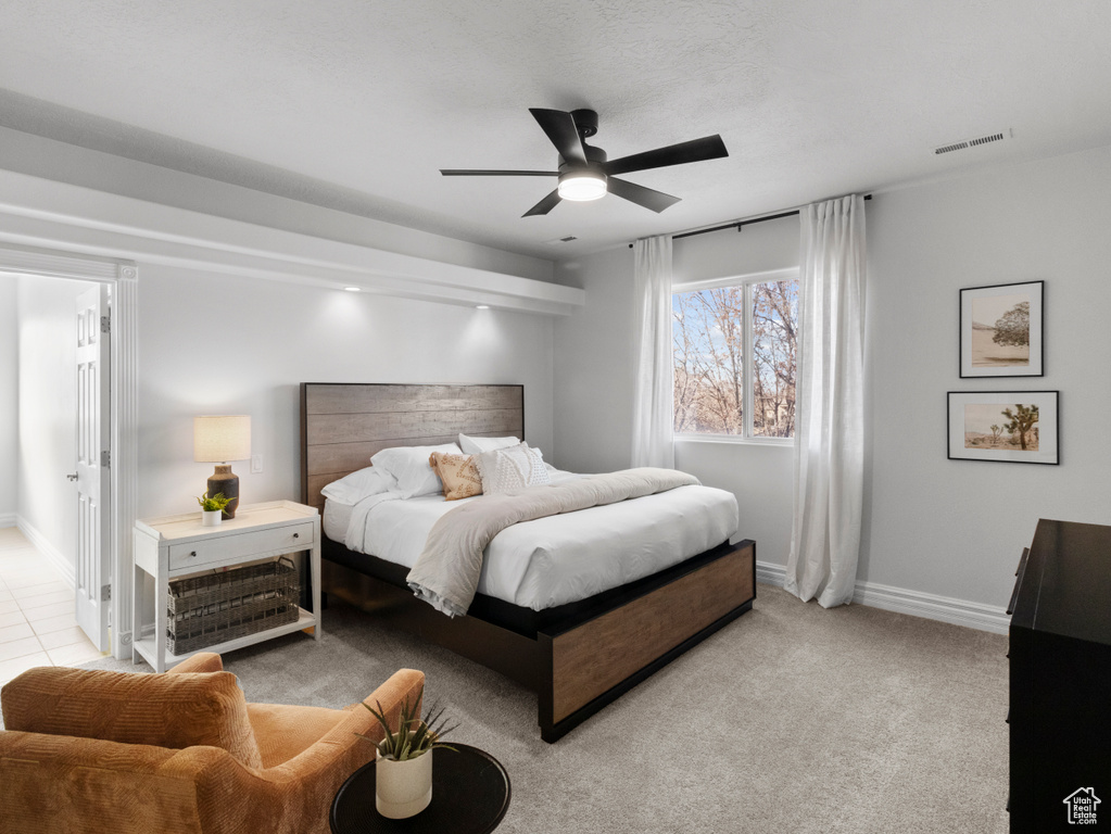 Bedroom with baseboards, a ceiling fan, and visible vents