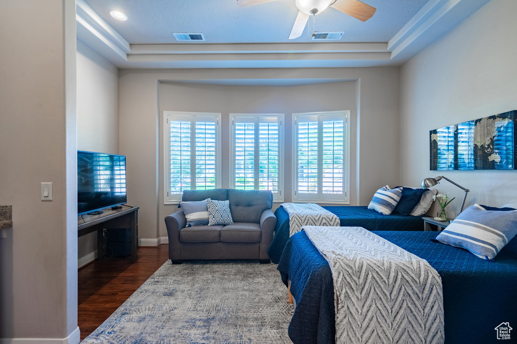Bedroom with visible vents, baseboards, a ceiling fan, and wood finished floors