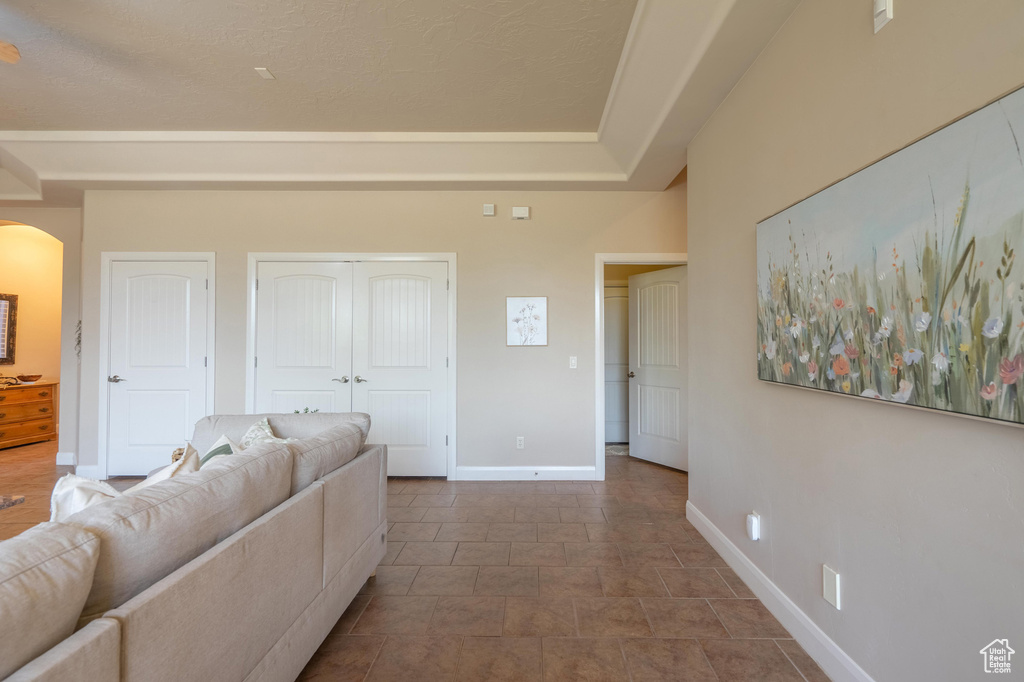Living room featuring baseboards and arched walkways