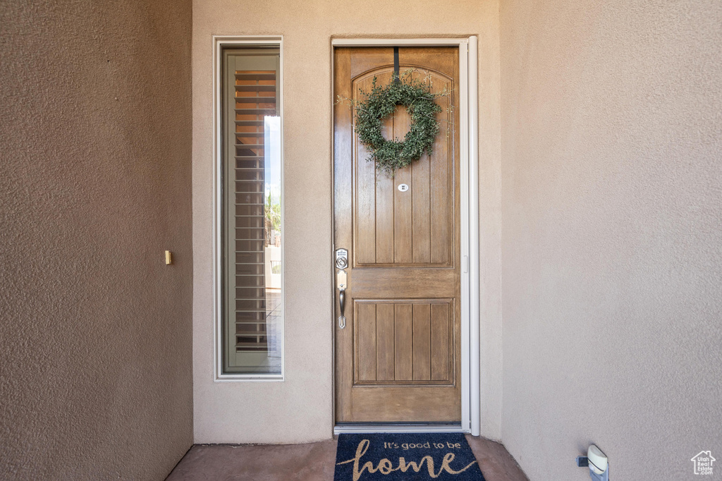 Entrance to property with stucco siding