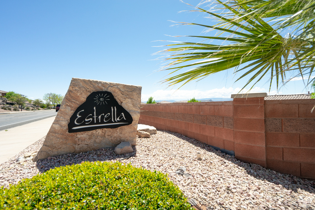 Community / neighborhood sign featuring fence