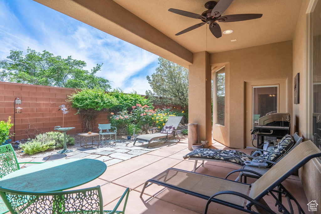 View of patio featuring a fenced backyard and ceiling fan