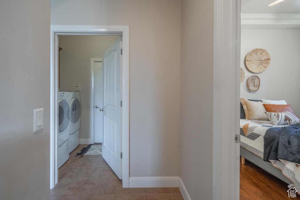 Laundry area featuring washing machine and dryer, baseboards, and laundry area