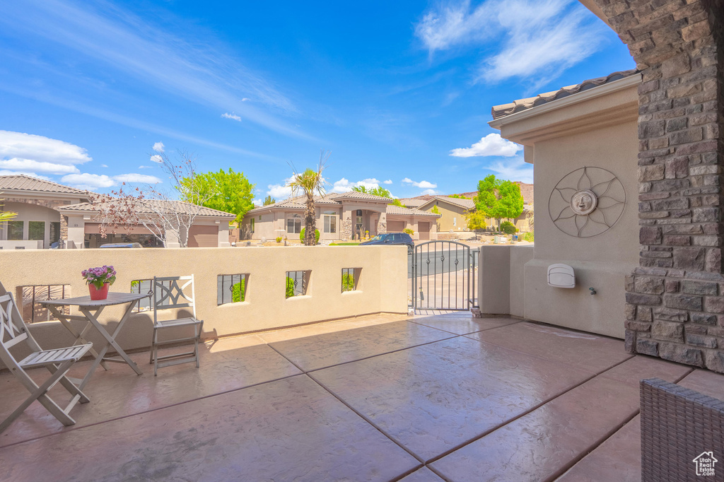 View of patio with a gate and a residential view