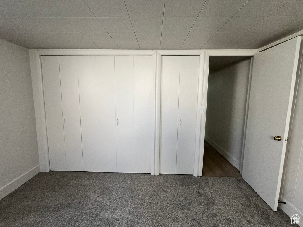 Unfurnished bedroom with carpet floors and baseboards