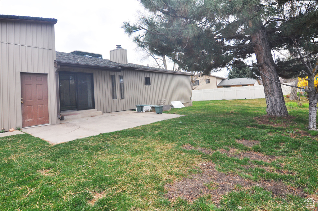 View of yard with a patio area and fence