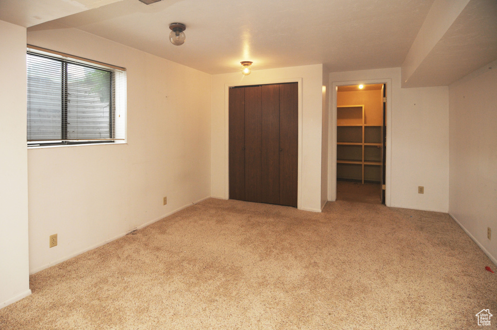 Unfurnished bedroom with a closet and carpet