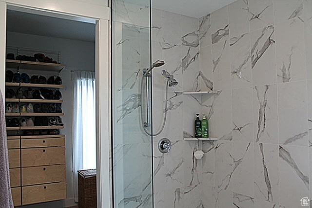 Bathroom featuring a marble finish shower