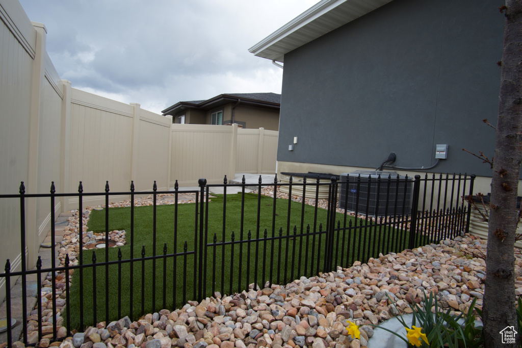 Exterior space featuring central AC and fence