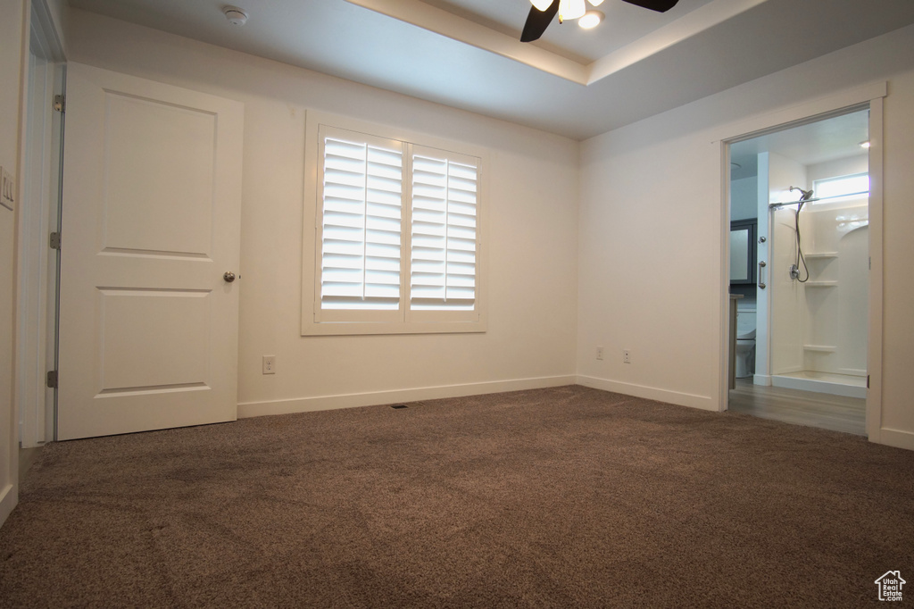 Unfurnished bedroom with baseboards, ensuite bathroom, and carpet flooring