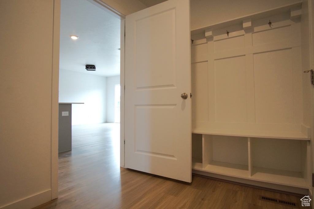 Mudroom featuring wood finished floors and visible vents