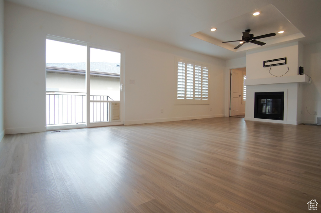 Unfurnished living room featuring recessed lighting, a wealth of natural light, light wood finished floors, and ceiling fan