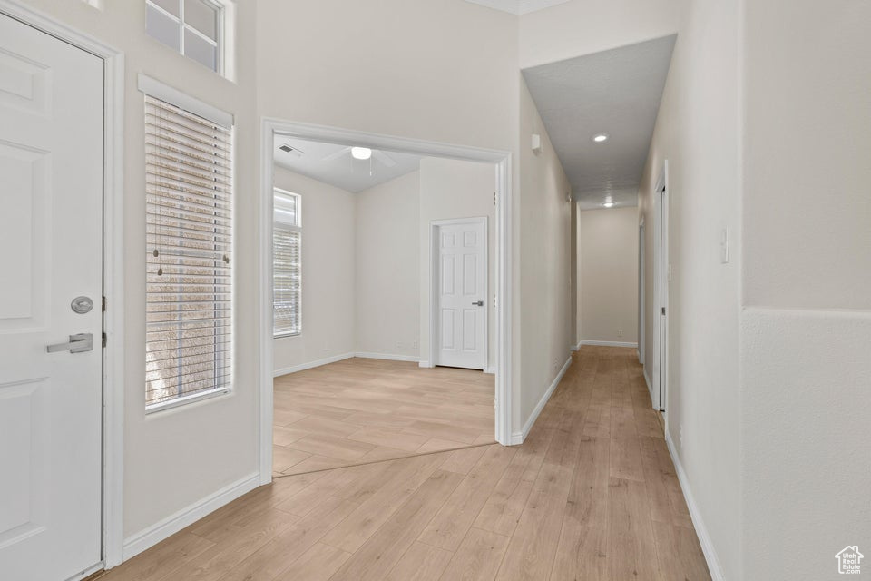 Foyer entrance featuring light wood-style floors and baseboards