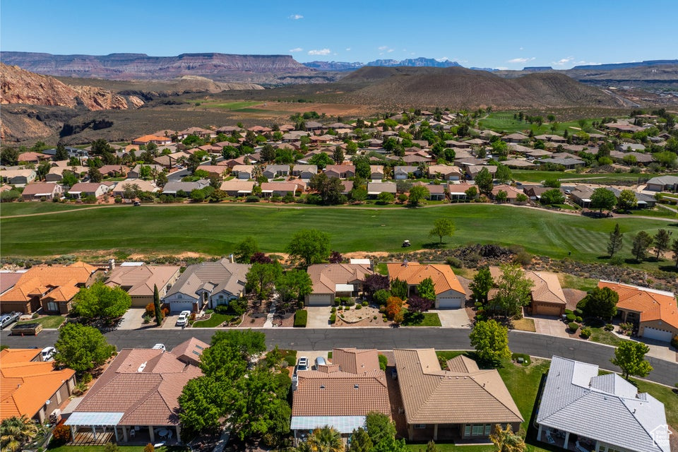 Aerial view of residential area featuring mountains and a golf course