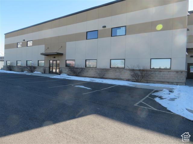 View of property featuring uncovered parking