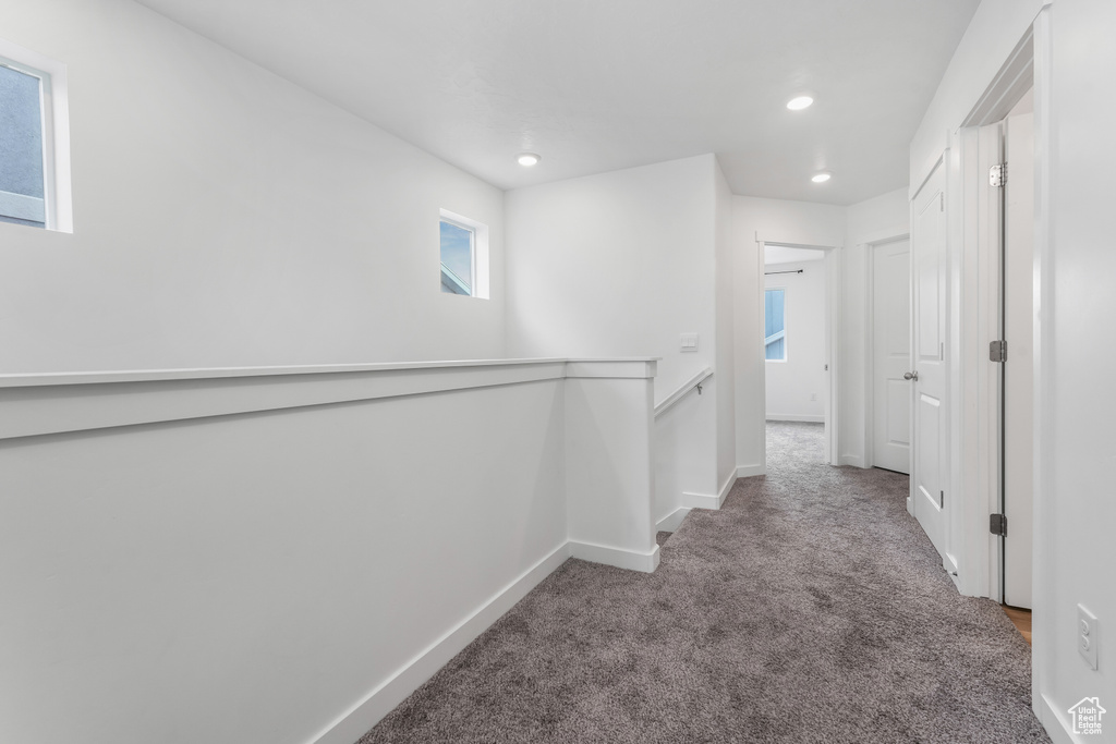 Corridor with baseboards, carpet floors, an upstairs landing, and recessed lighting