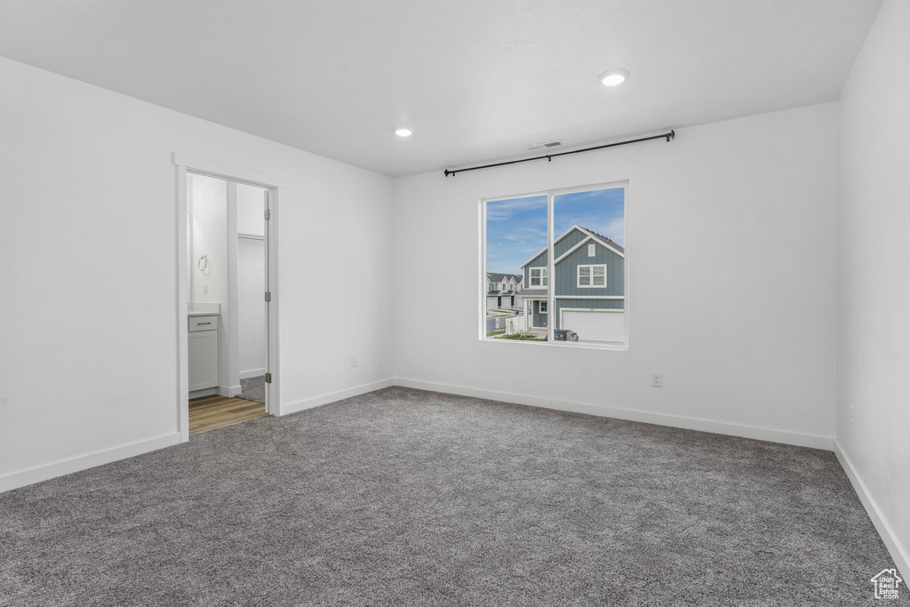 Unfurnished bedroom with recessed lighting, carpet floors, baseboards, and connected bathroom