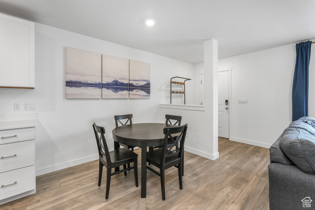 Dining room featuring recessed lighting, light wood finished floors, and baseboards