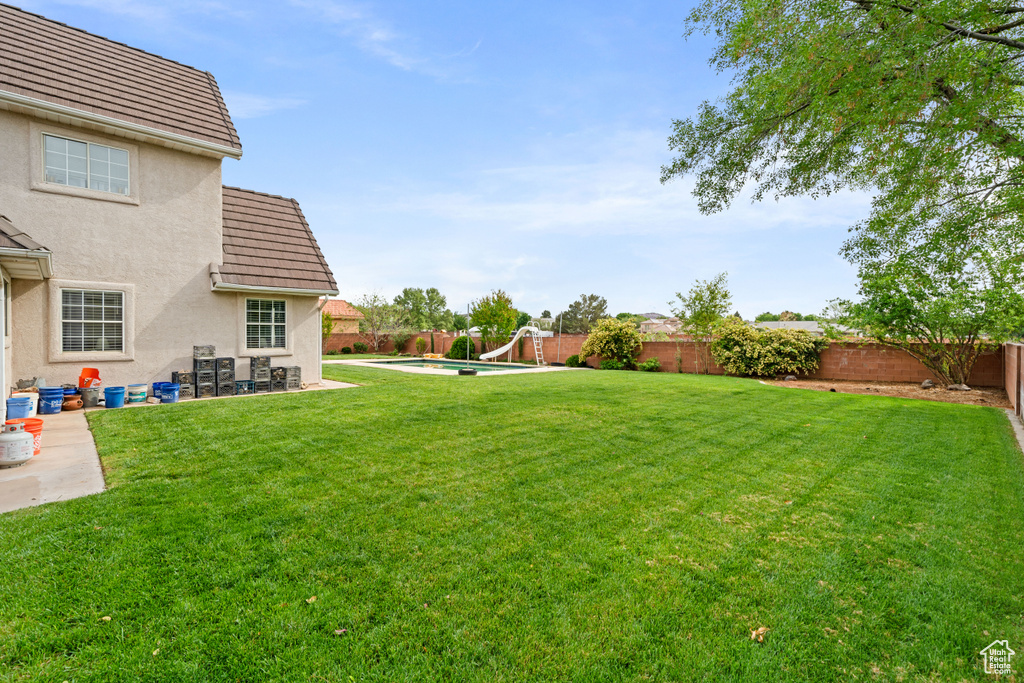 View of yard featuring a fenced in pool, a patio, and a fenced backyard