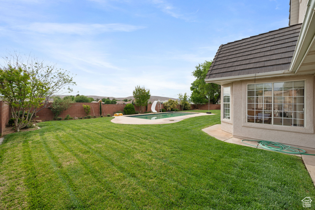View of yard with a fenced in pool and a fenced backyard