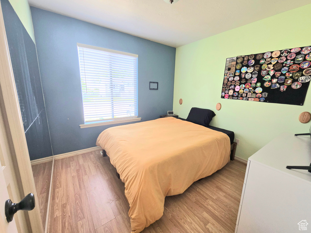 Bedroom featuring light wood-style floors and baseboards