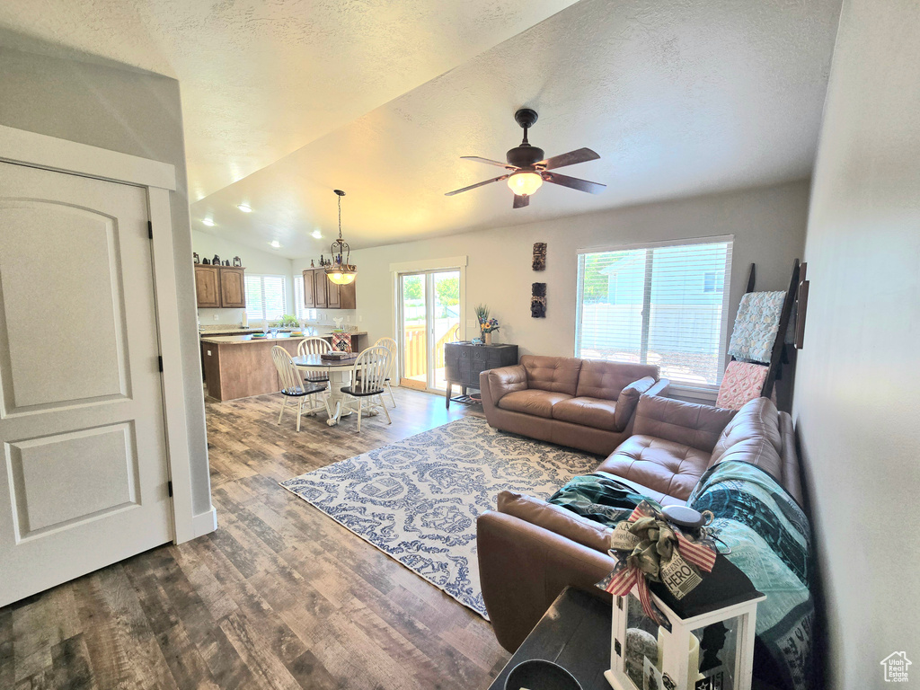 Living area featuring dark wood finished floors, a ceiling fan, and a textured ceiling