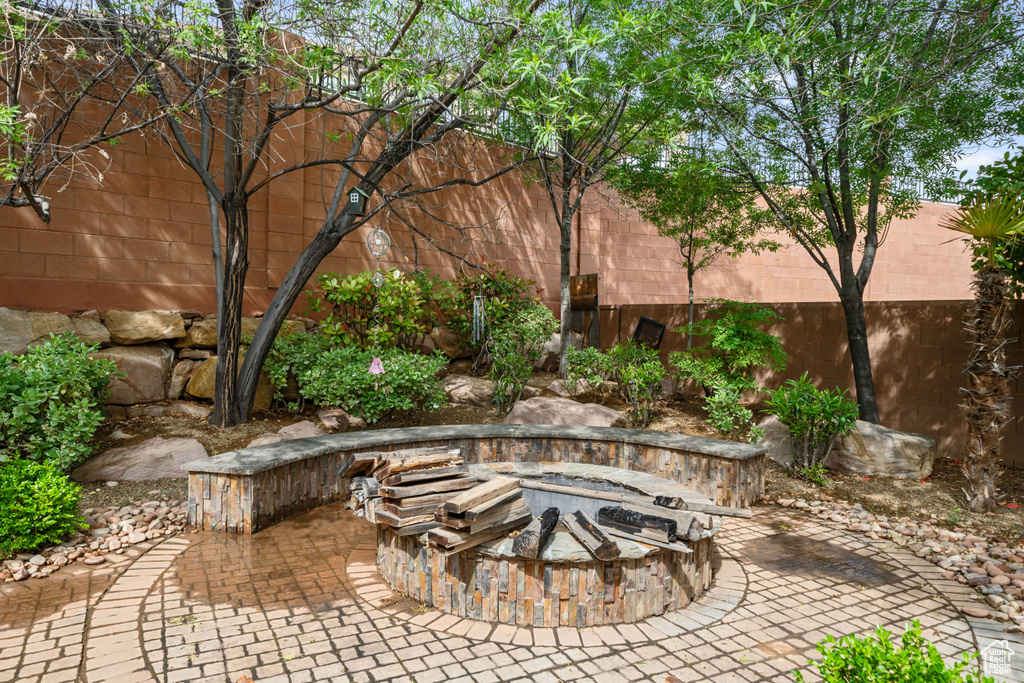 View of patio / terrace featuring fence and an outdoor fire pit