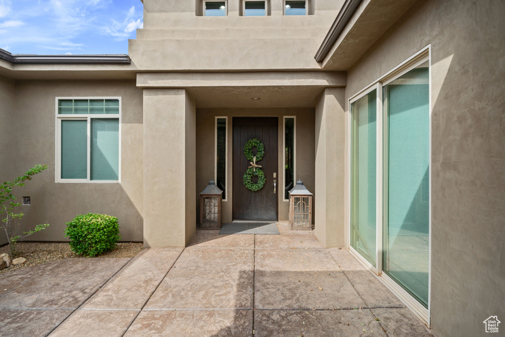 Entrance to property featuring a patio area and stucco siding