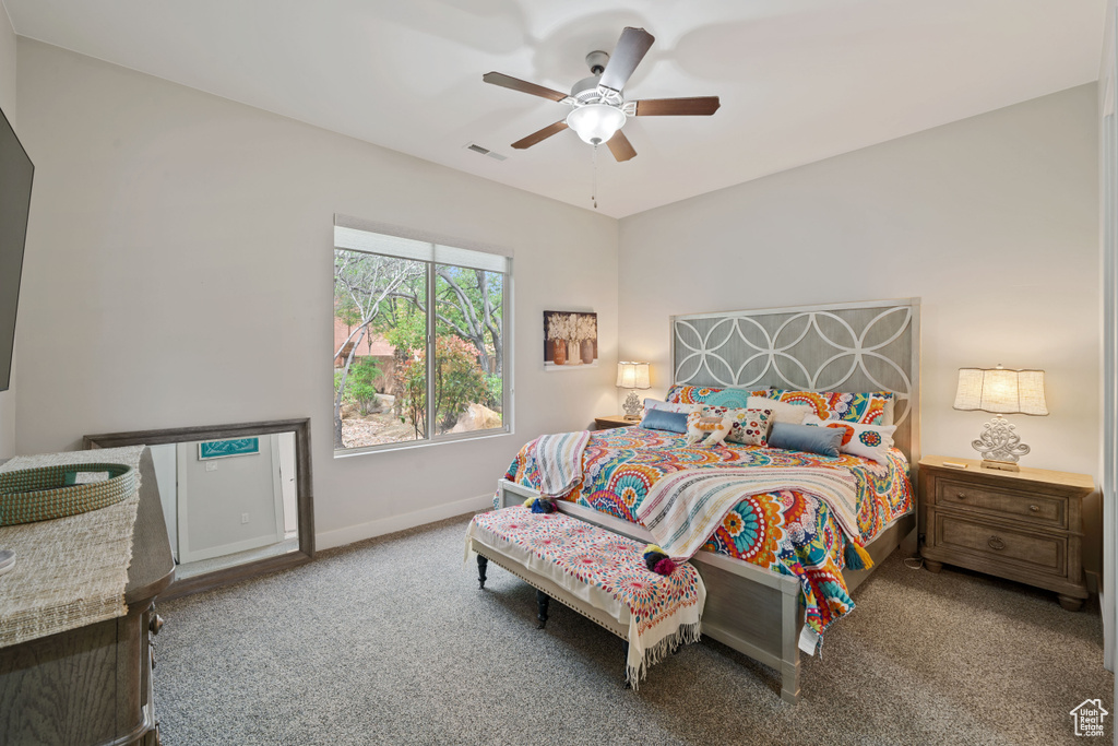 Bedroom featuring baseboards, a ceiling fan, carpet flooring, and visible vents