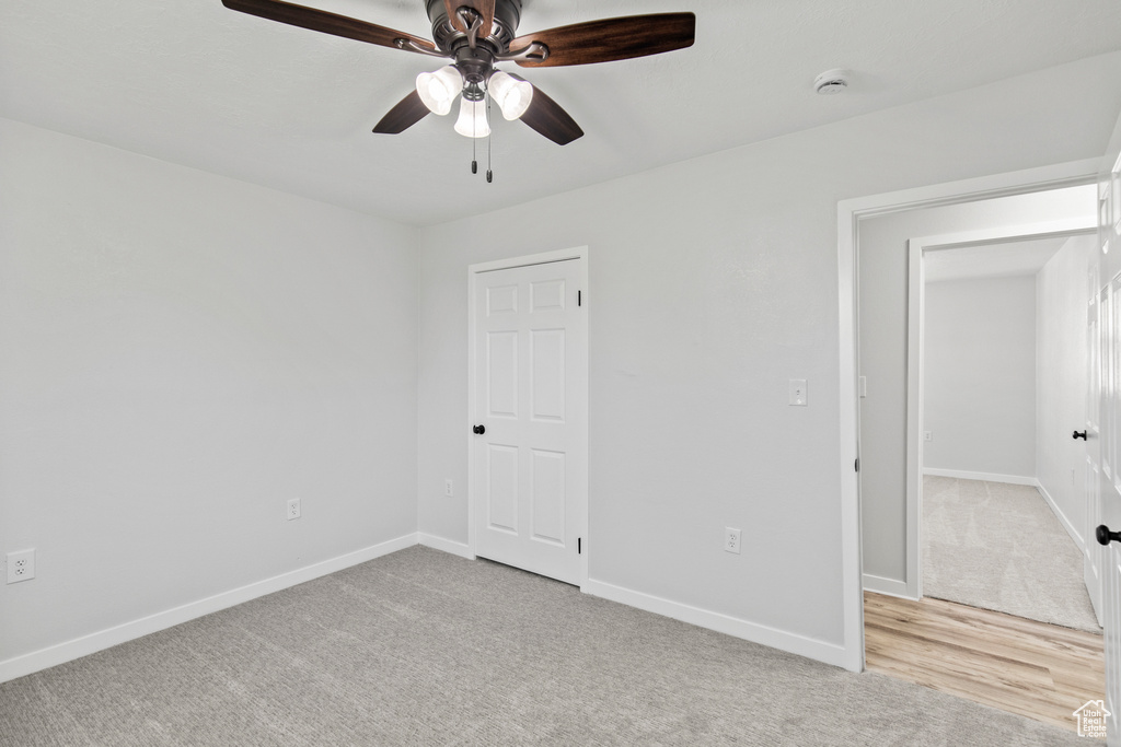 Unfurnished bedroom featuring ceiling fan, carpet flooring, and baseboards