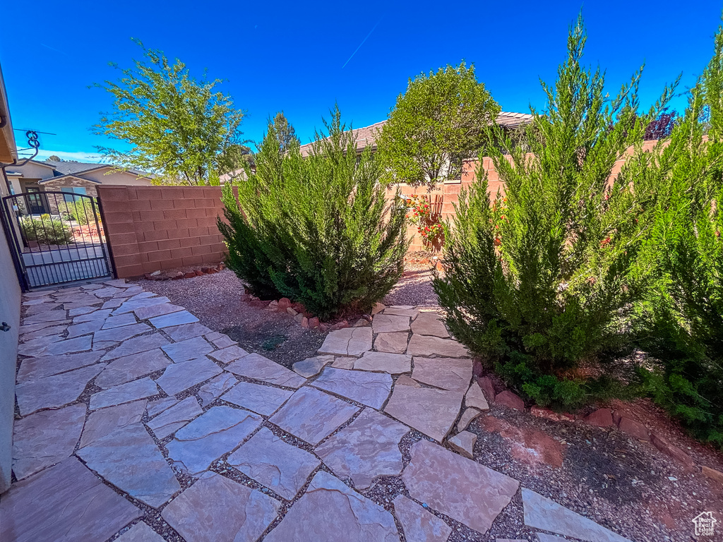 View of patio with a gate and fence