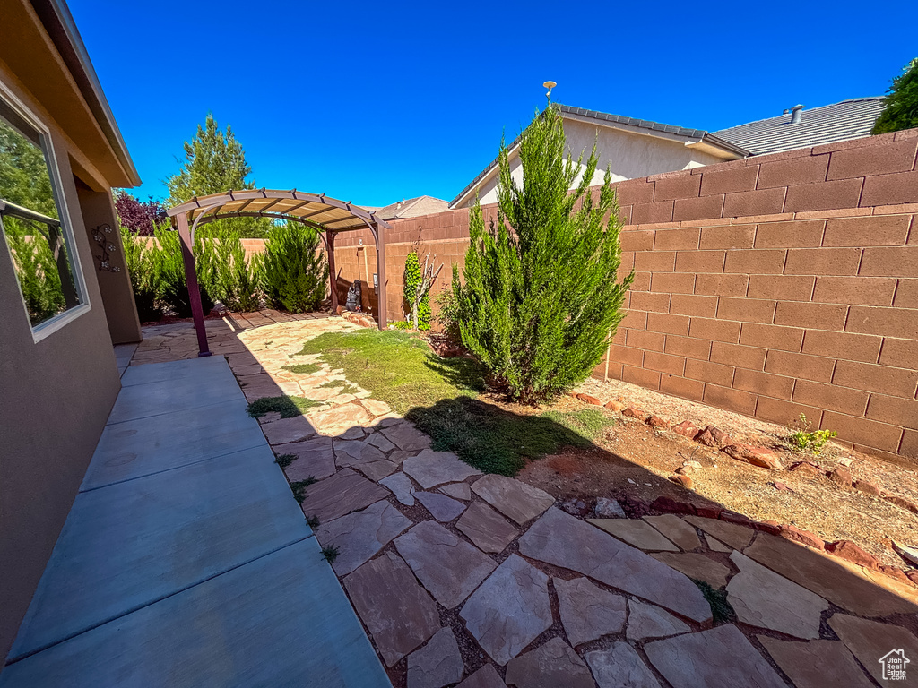 View of yard with a pergola, a fenced backyard, and a patio