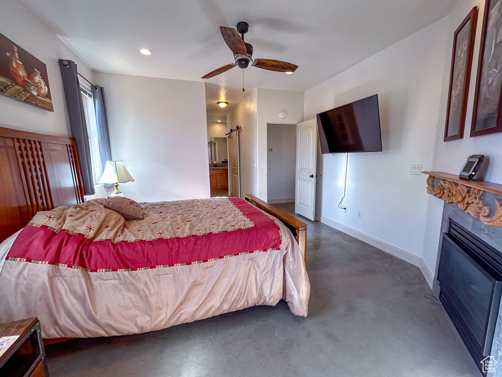 Bedroom with recessed lighting, concrete flooring, baseboards, a glass covered fireplace, and ceiling fan