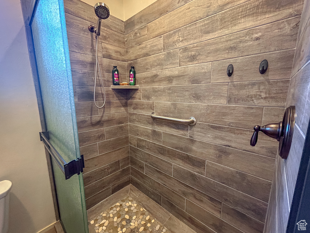 Bathroom featuring toilet and a stall shower