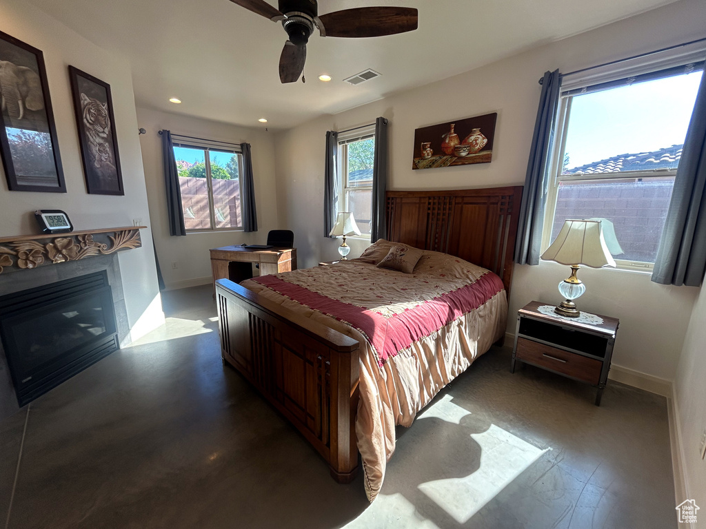 Bedroom with recessed lighting, visible vents, a ceiling fan, baseboards, and a glass covered fireplace