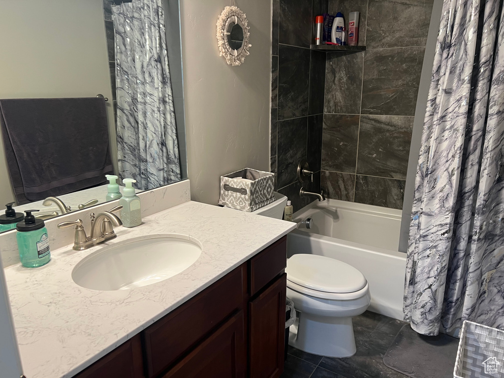 Full bath featuring shower / bath combo, toilet, and vanity