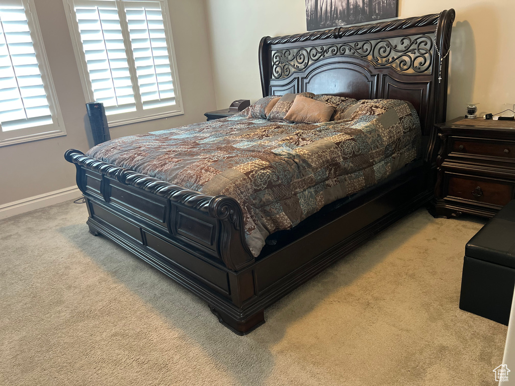 Bedroom with carpet floors, multiple windows, and baseboards