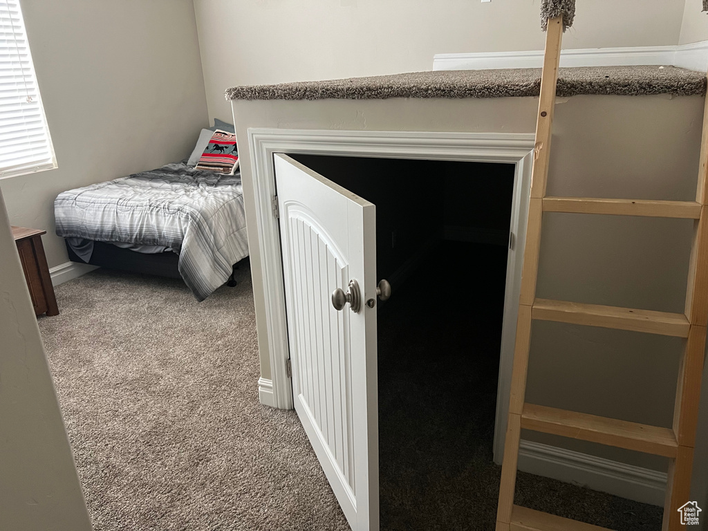 Carpeted bedroom with baseboards