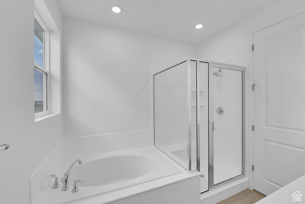 Full bath featuring a shower stall, a bath, and recessed lighting