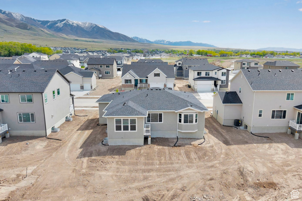 Aerial perspective of suburban area with a mountainous background