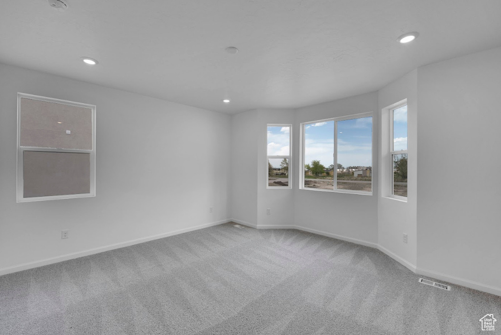 Spare room with carpet floors, recessed lighting, and baseboards