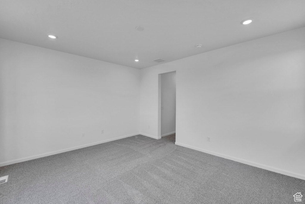 Empty room with recessed lighting, carpet, and baseboards