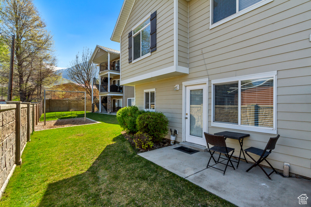 View of yard with a fenced backyard and a patio