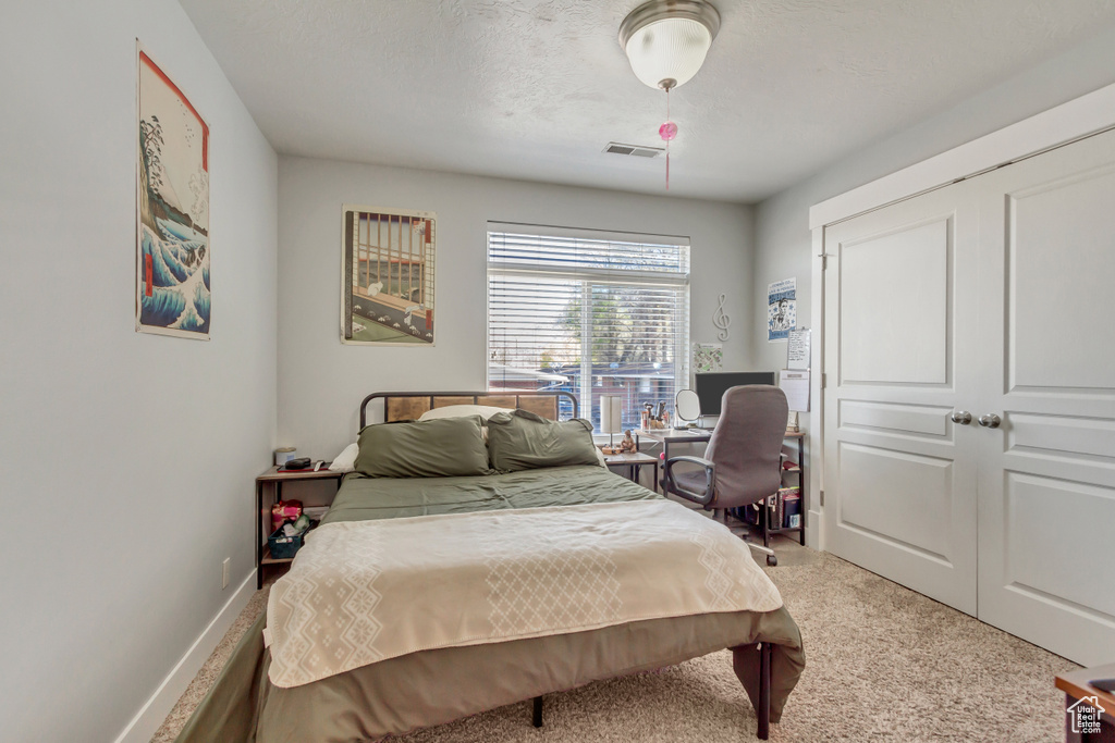 Bedroom featuring baseboards, visible vents, and carpet flooring