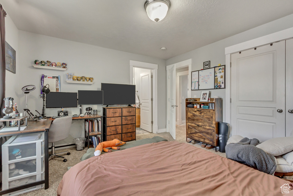 Bedroom featuring light carpet and baseboards